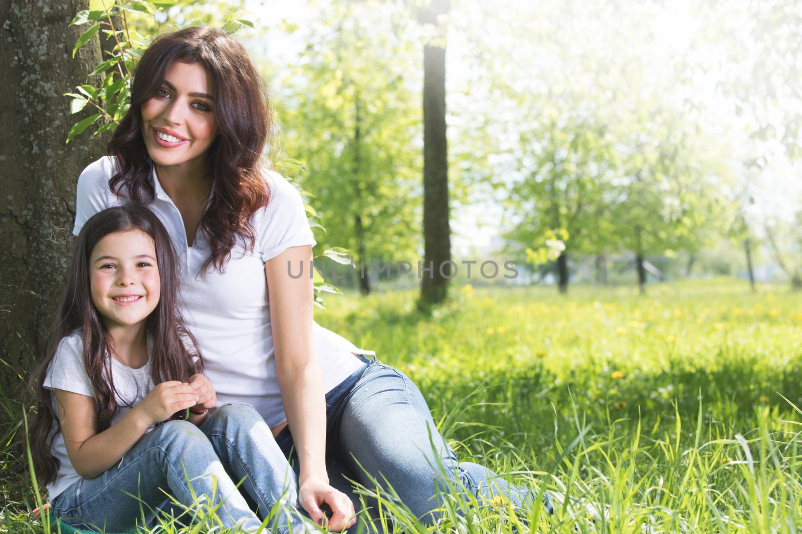 Young mother and daughter in park by Yellowj