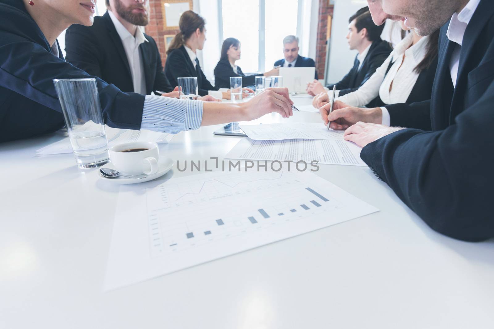 Group of business people in meeting room at office discuss financial reports
