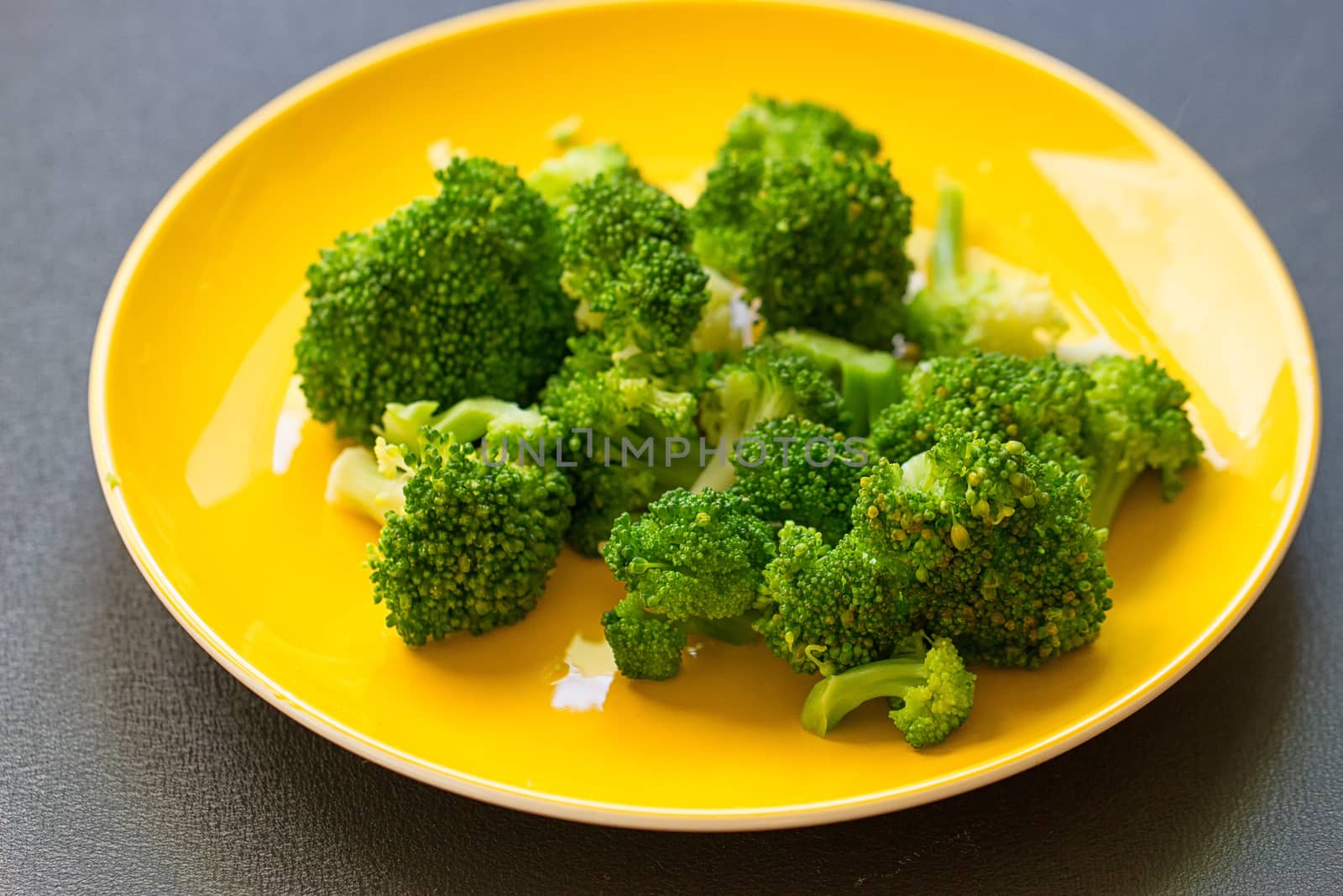Fresh broccoli cut in yellow plate healthy natural clean food vegetable on wood background