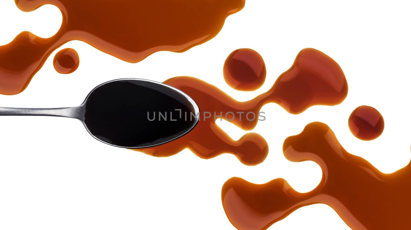 Soy sauce. Splashes and spilled soy sauce with spoon isolated on white background with clipping path. Top view