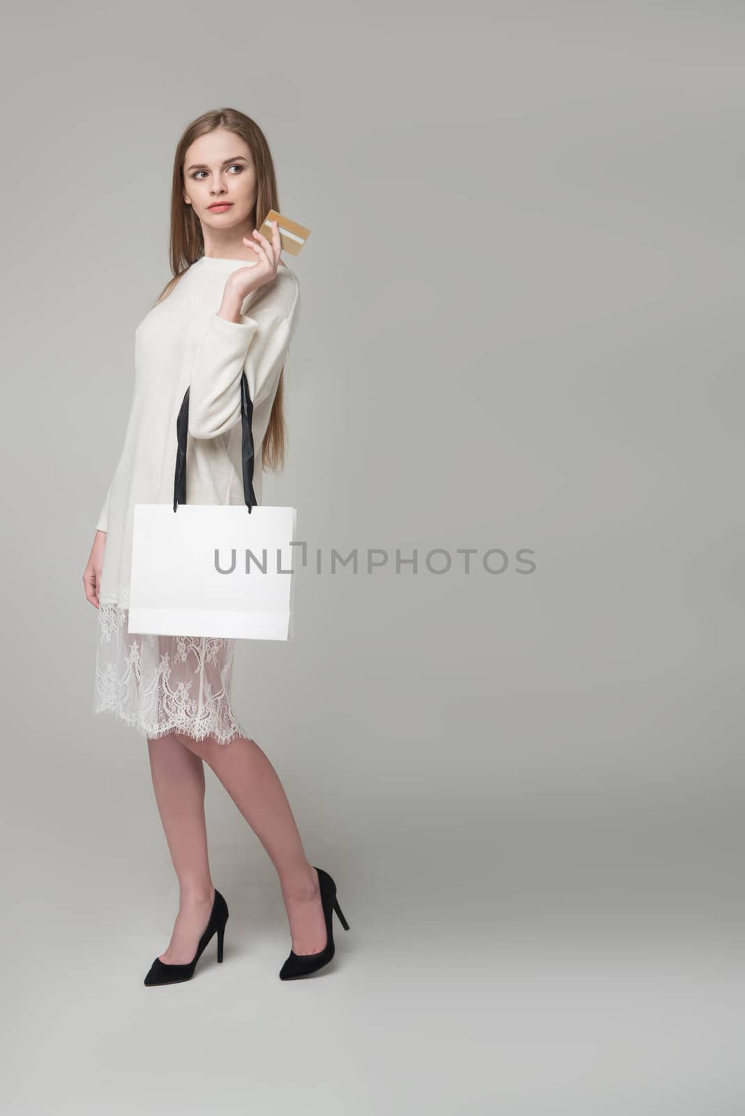 Blond girl in white lace short dress with shopping bag by VeraVerano