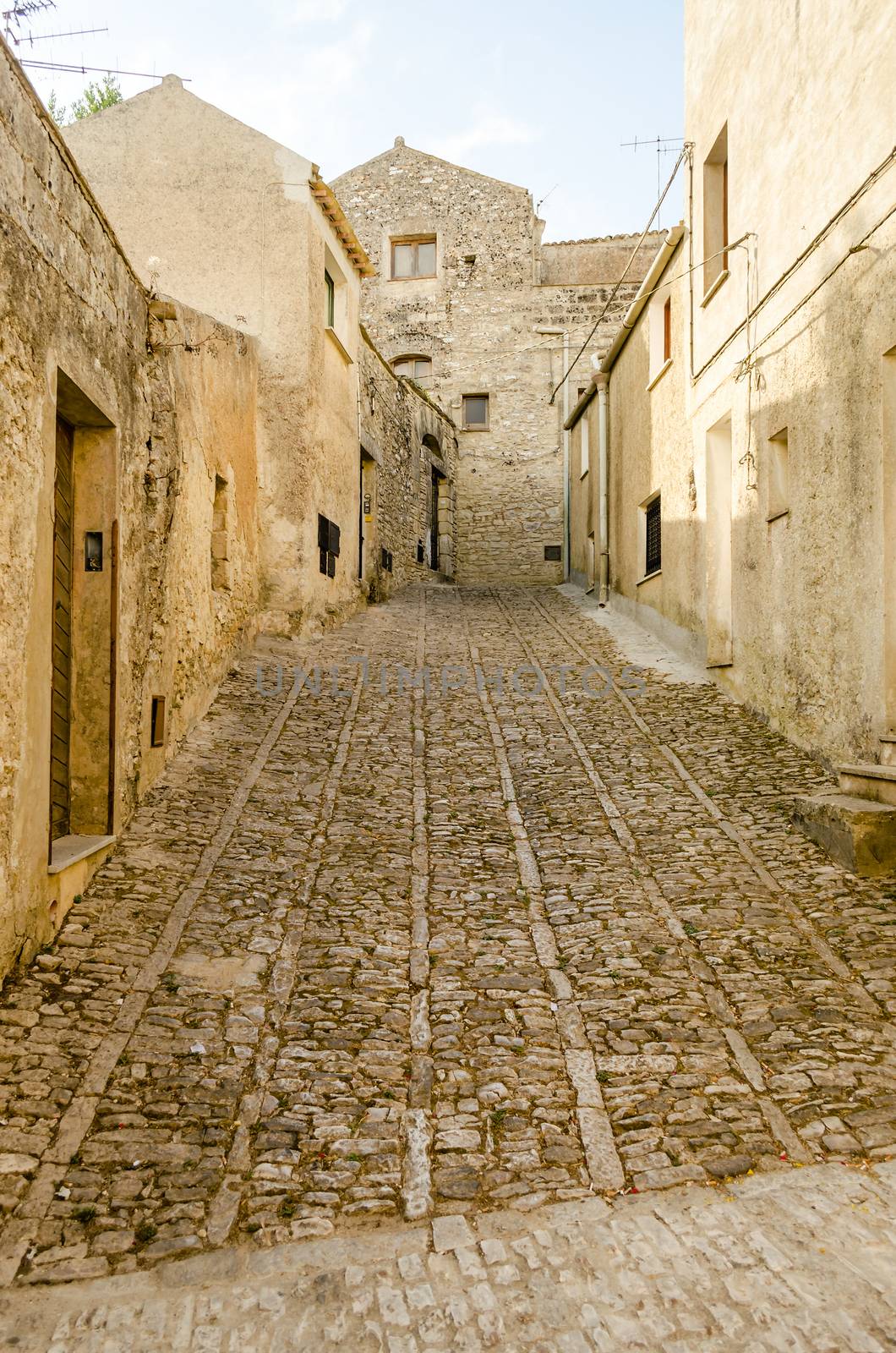 Stone paved ancient medieval street in the town of Erice, Sicily, Italy