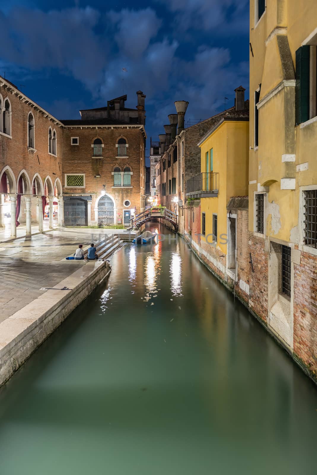 View over a picturesque canal and little bridge at night in San Polo district of Venice, Italy