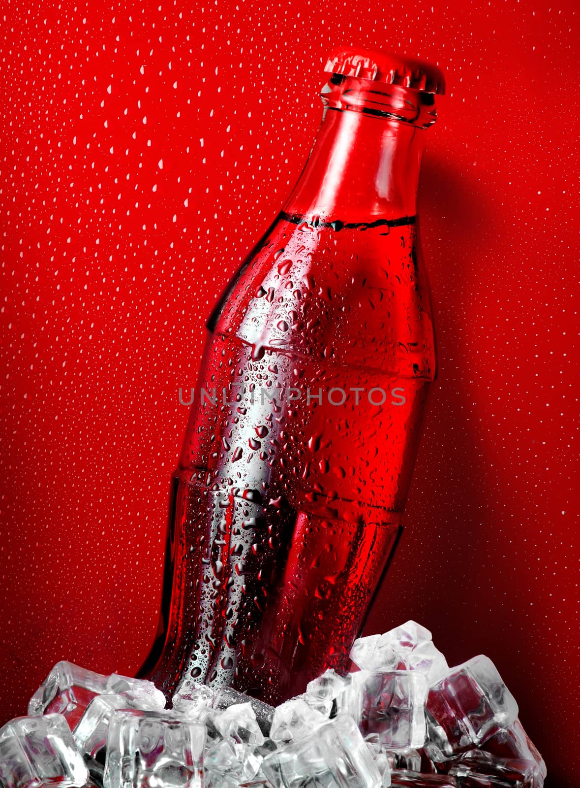 Cola in ice on a red background