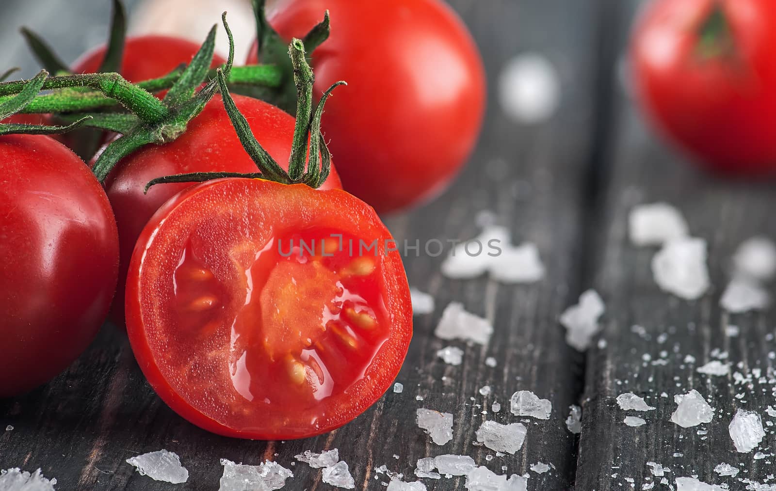 Sliced cherry tomato and salt by Cipariss