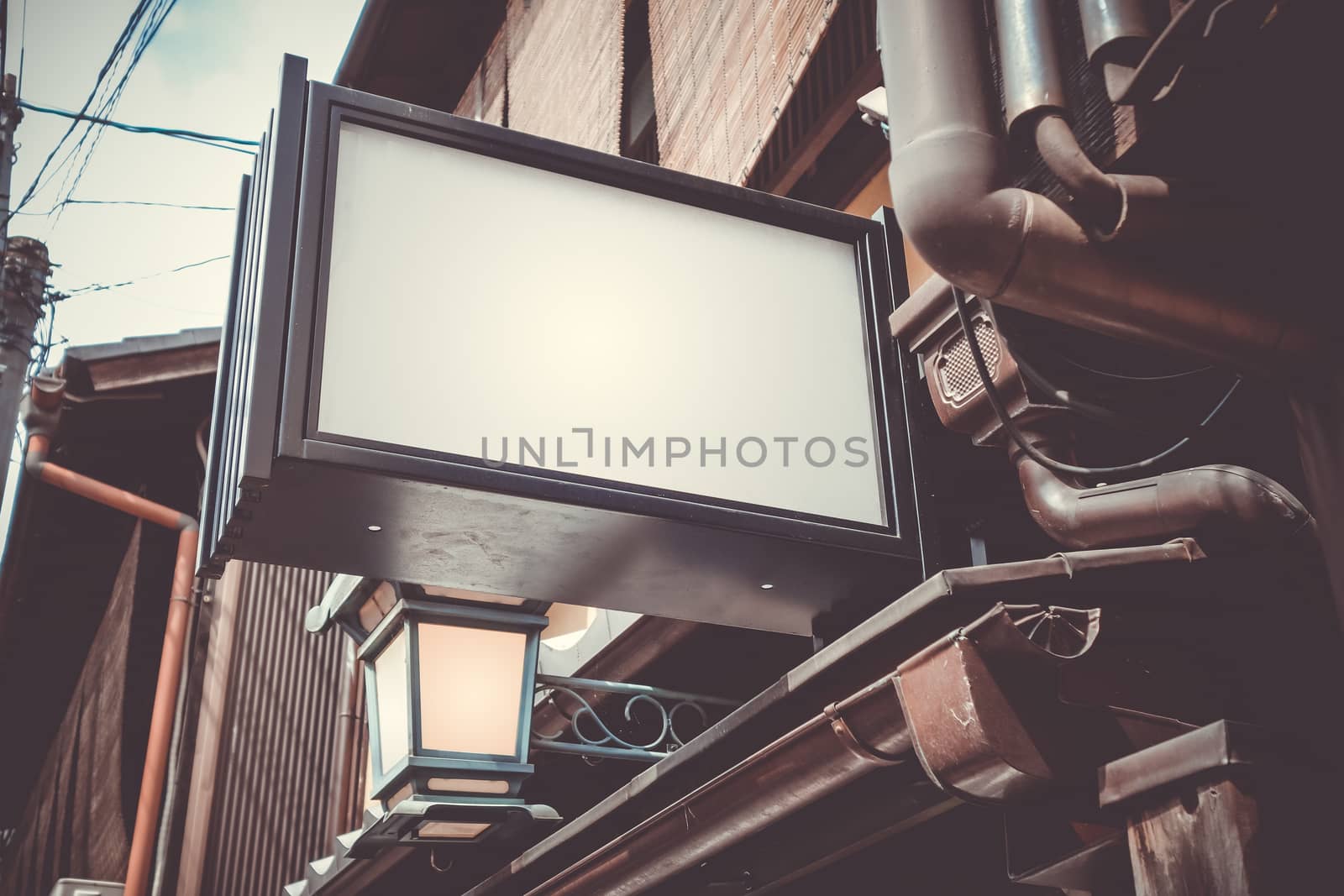 Blank advertising lightbox in a traditional Kyoto street, Japan