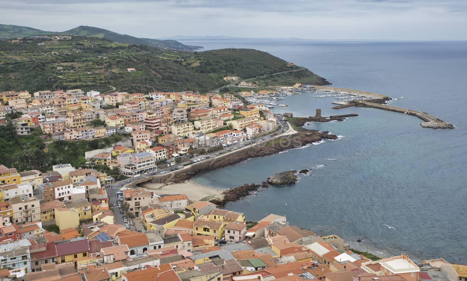 skyline and the houses and the harbour with old tower of castelsardo on sardinia island