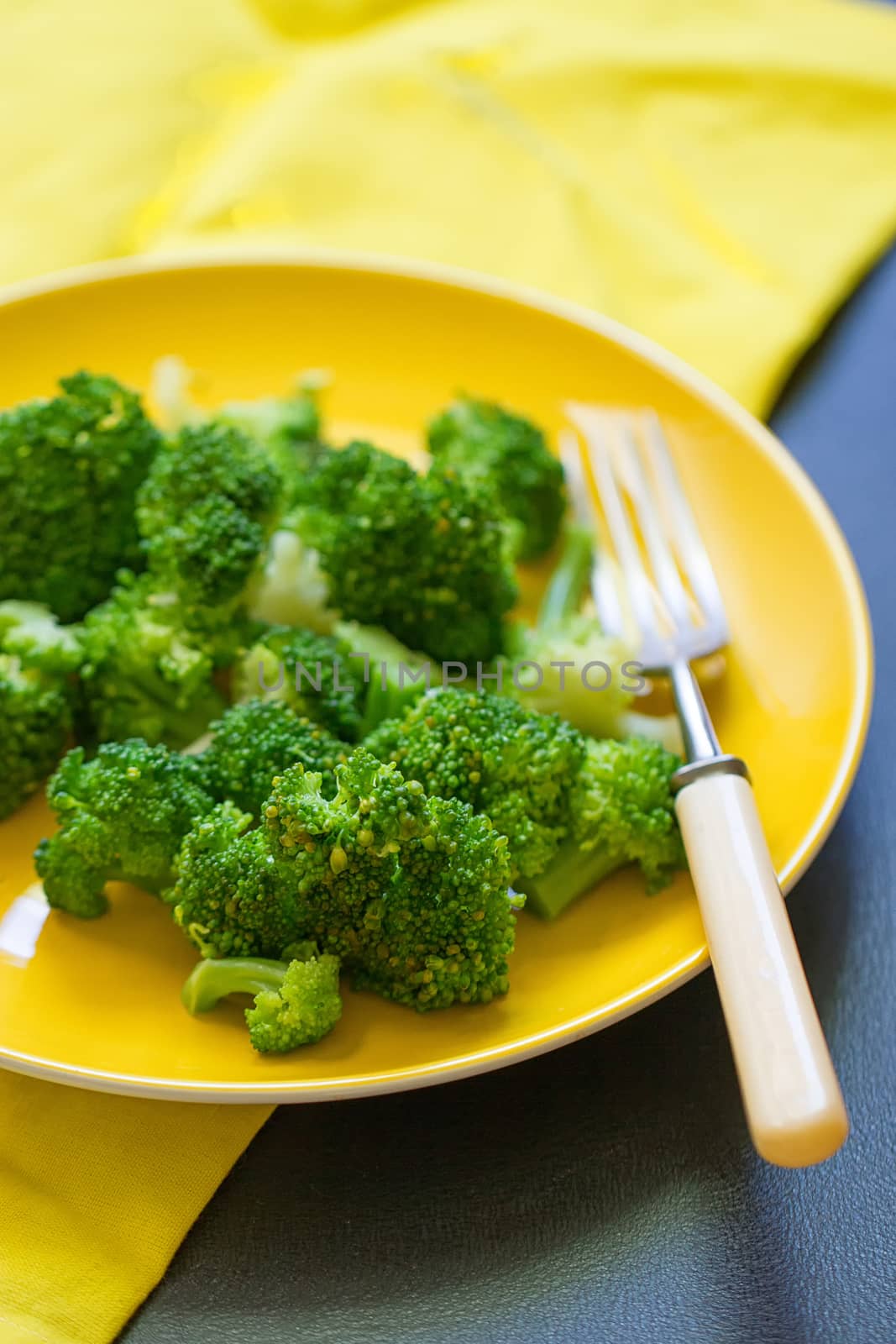 Fresh broccoli cut in yellow plate healthy natural clean food vegetable on wood background