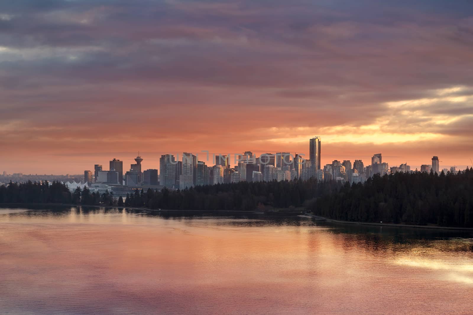 Colorful dramatic sunset color sky over Stanley Park and downtown city Vancouver BC British Columbia Canada