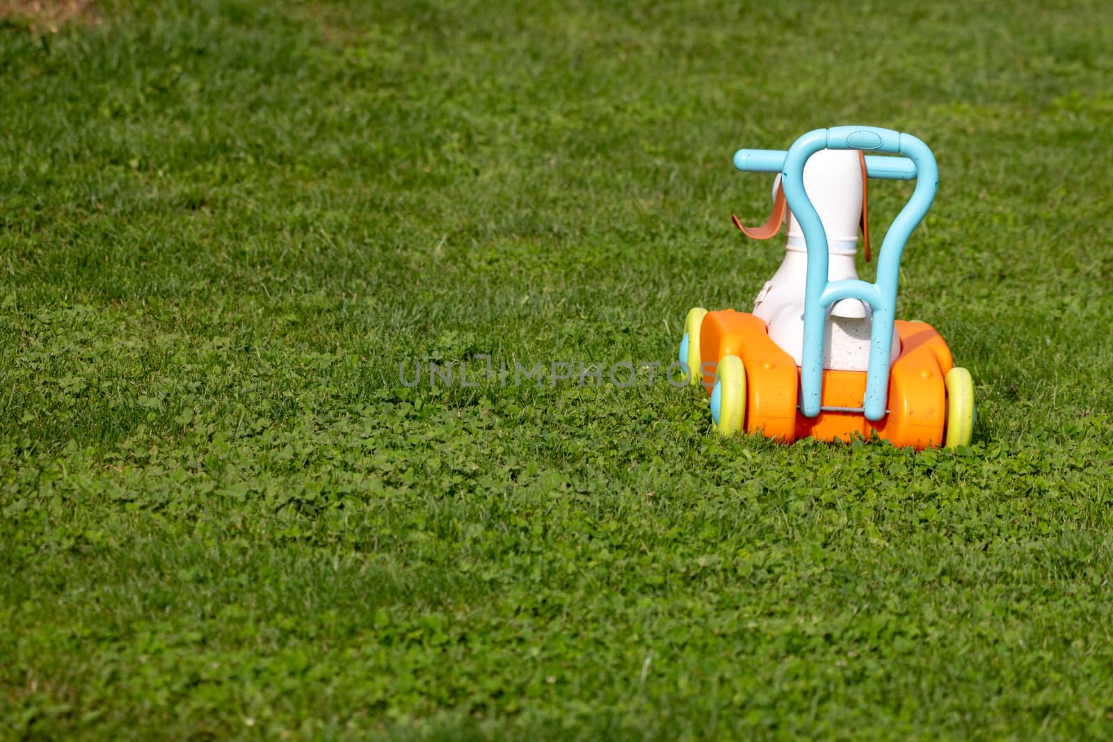 Toy truck on grass, abandoned toy by asafaric