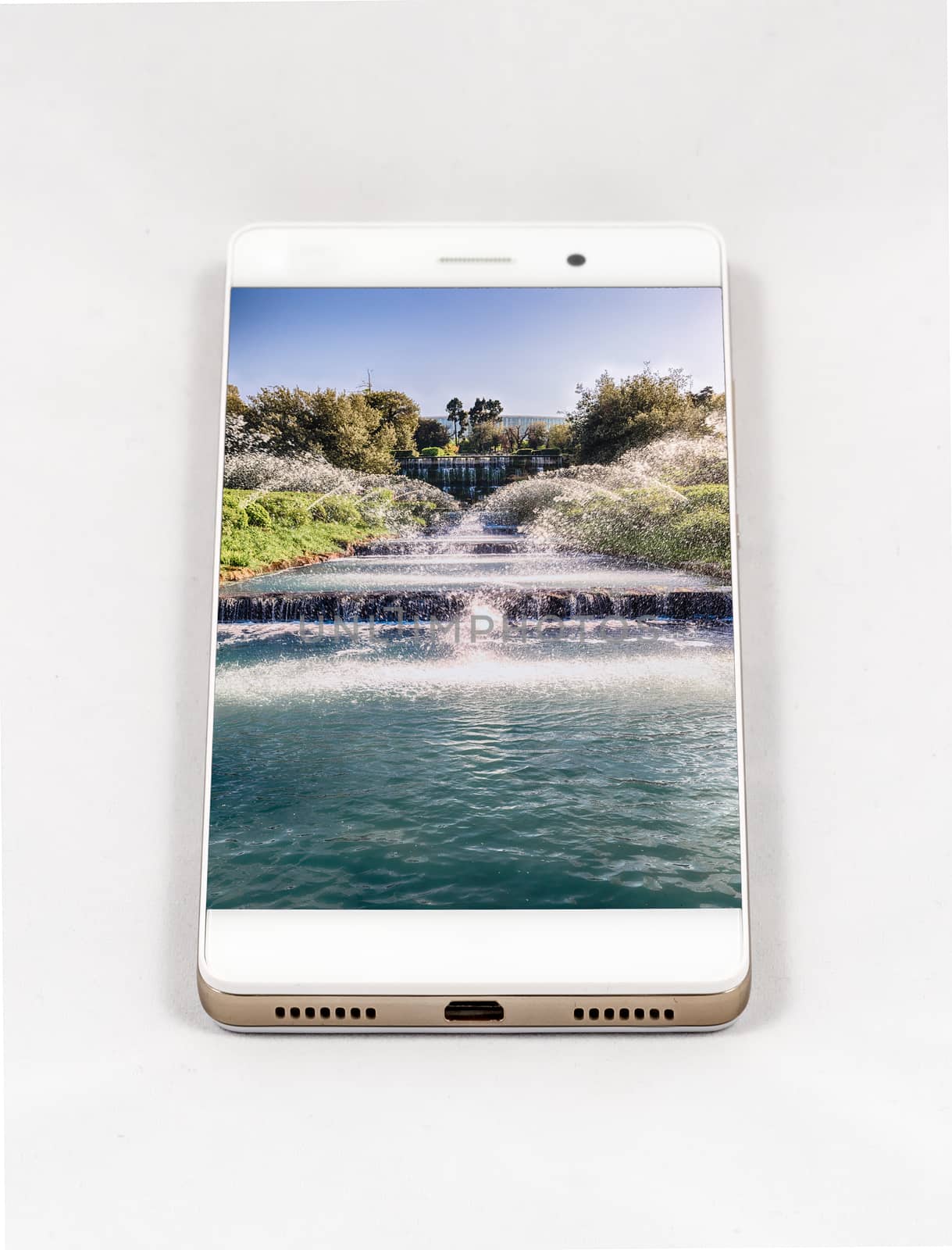 Modern smartphone with full screen picture of waterfall in Rome, Italy. Concept for travel smartphone photography. All images in this composition are made by me and separately available on my portfolio