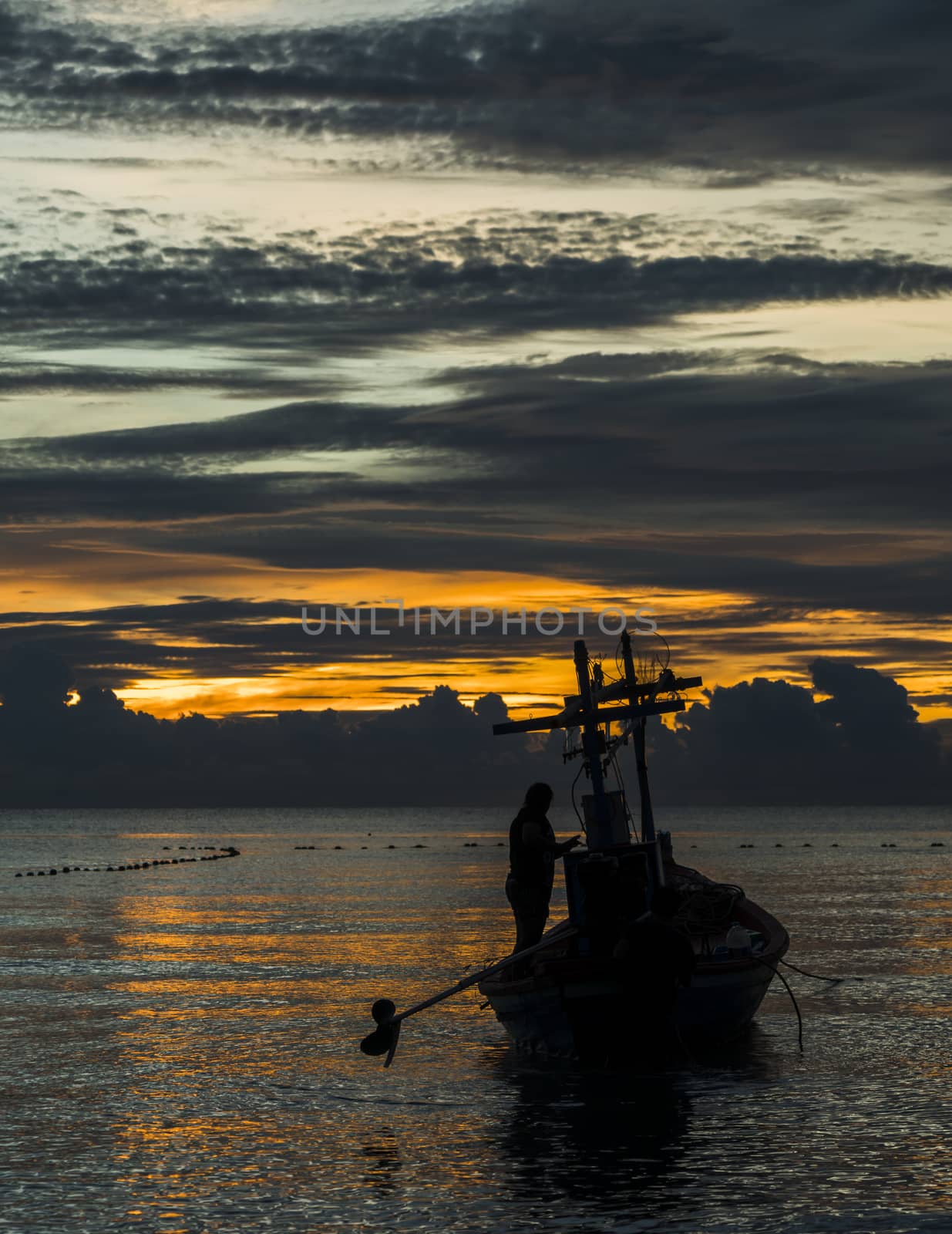 A fishing boat is ready to work in dawn.