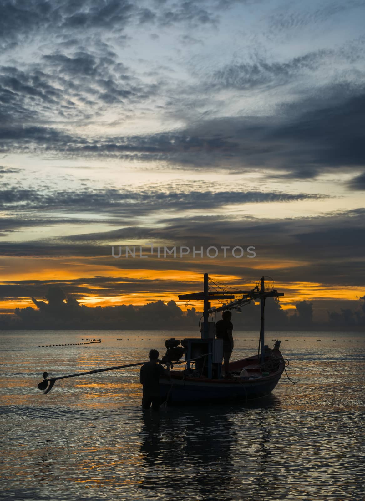 A fishing boat is ready to work in dawn.