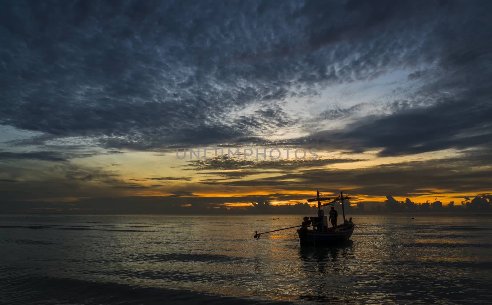 A beautiful tropical dawn with a fishing boat.