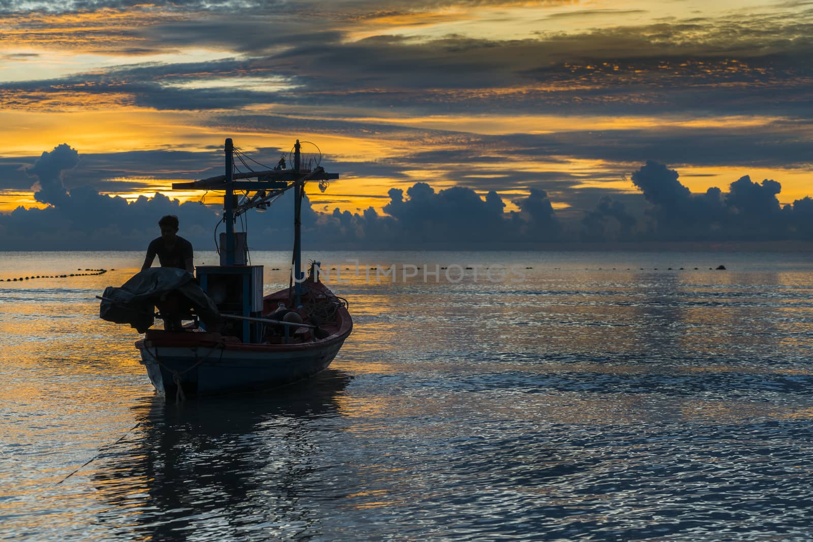 Fisherman prepare for work in dawn.