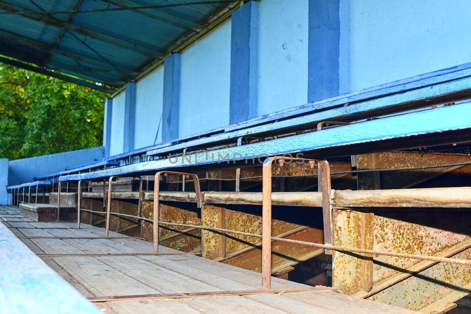 Old grandstand seats. Vintage tone. Old blue wooden grandstand stadium by roman_nerud