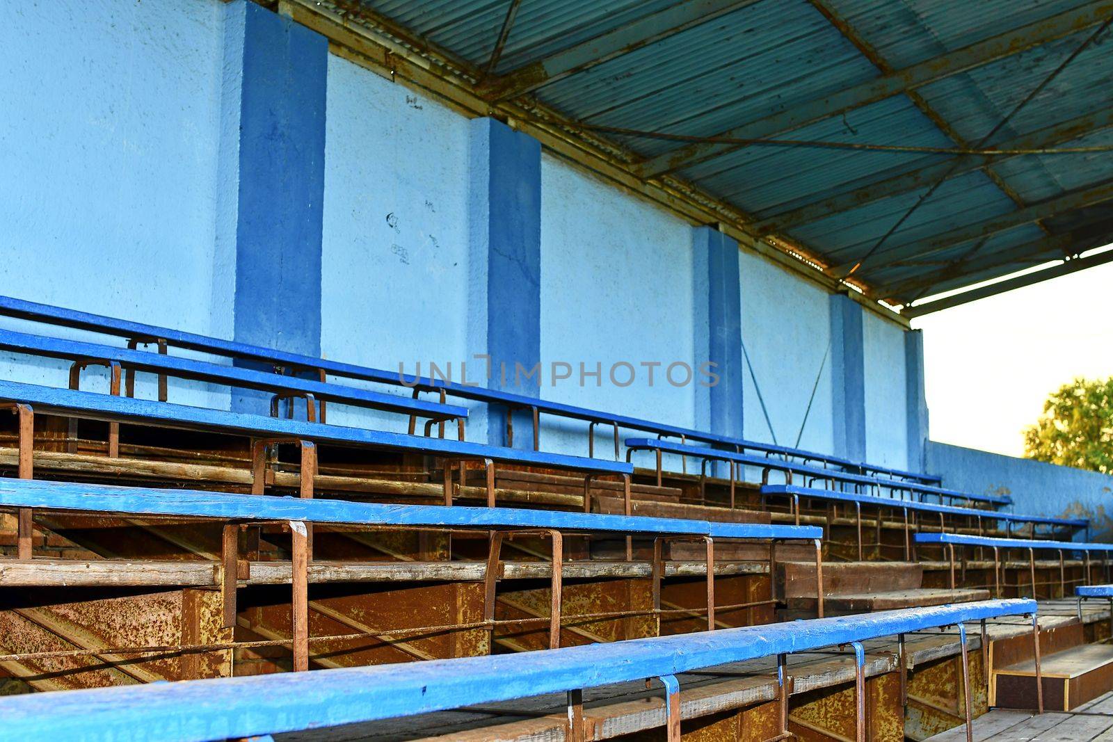 Old grandstand seats. Vintage tone. Old blue wooden grandstand stadium by roman_nerud