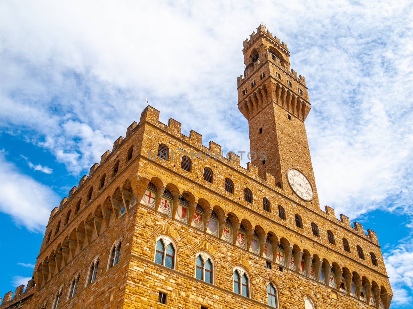 Bottom view of Pallazo Vecchio, Old Palace - Town Hall, with high bell tower, Piazza della Signoria, Florence, Tuscany, Italy.