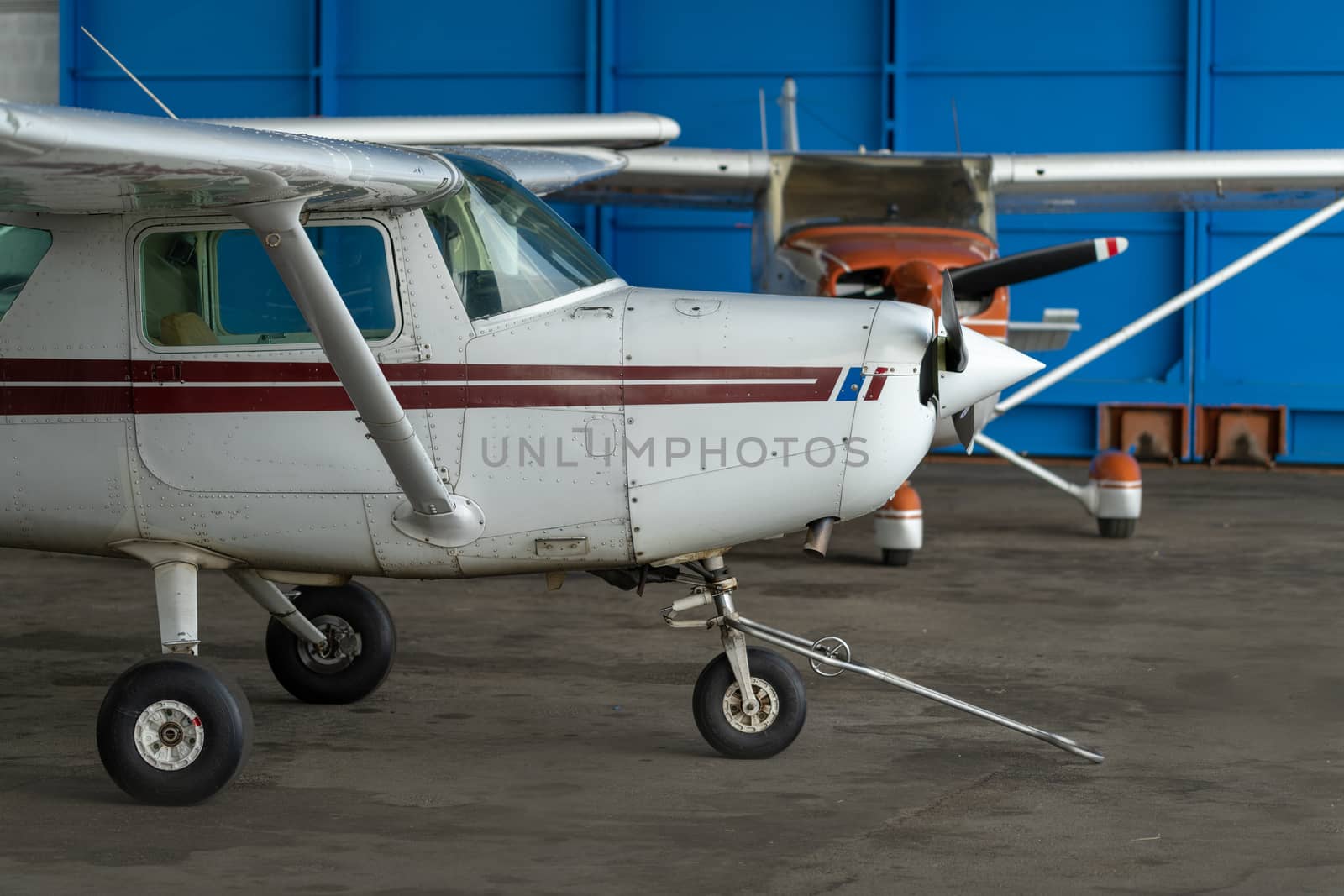 Small Sport Aircraft parked in hangar, close up. detail by asafaric