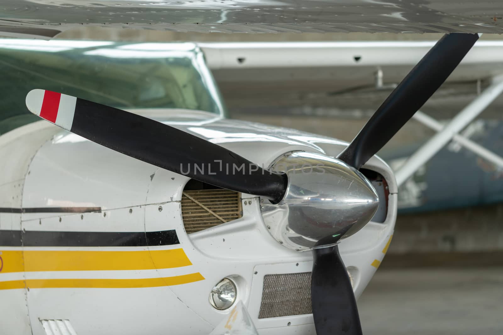 Small Sport Aircraft parked in hangar, close up. detail by asafaric