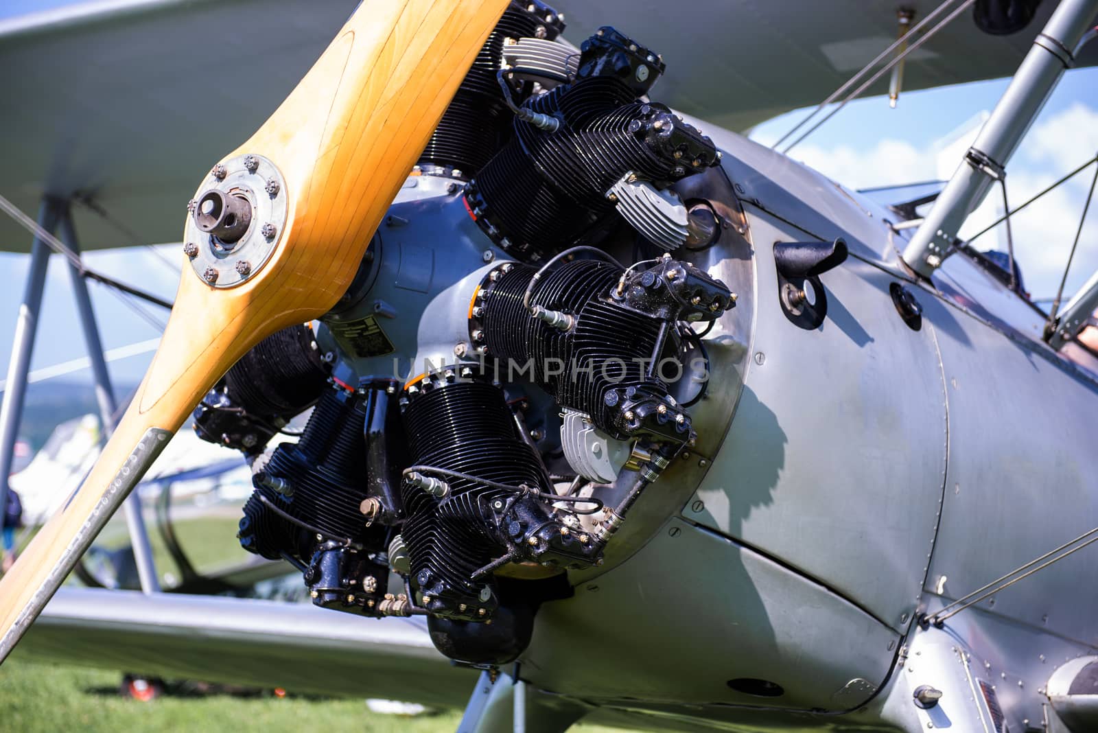 Vintage aircraft with radial engine and wooden propeller, close up of nose section by asafaric