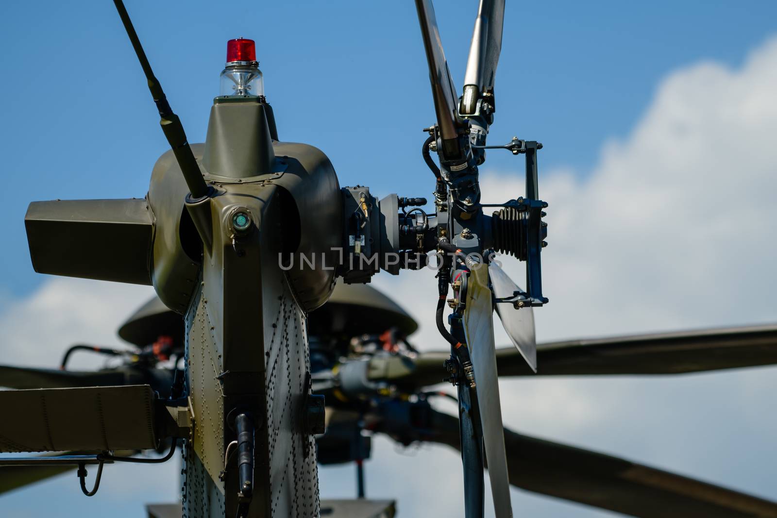 Detail of tail rotor of military helicopter, main rotor in background, selective focus