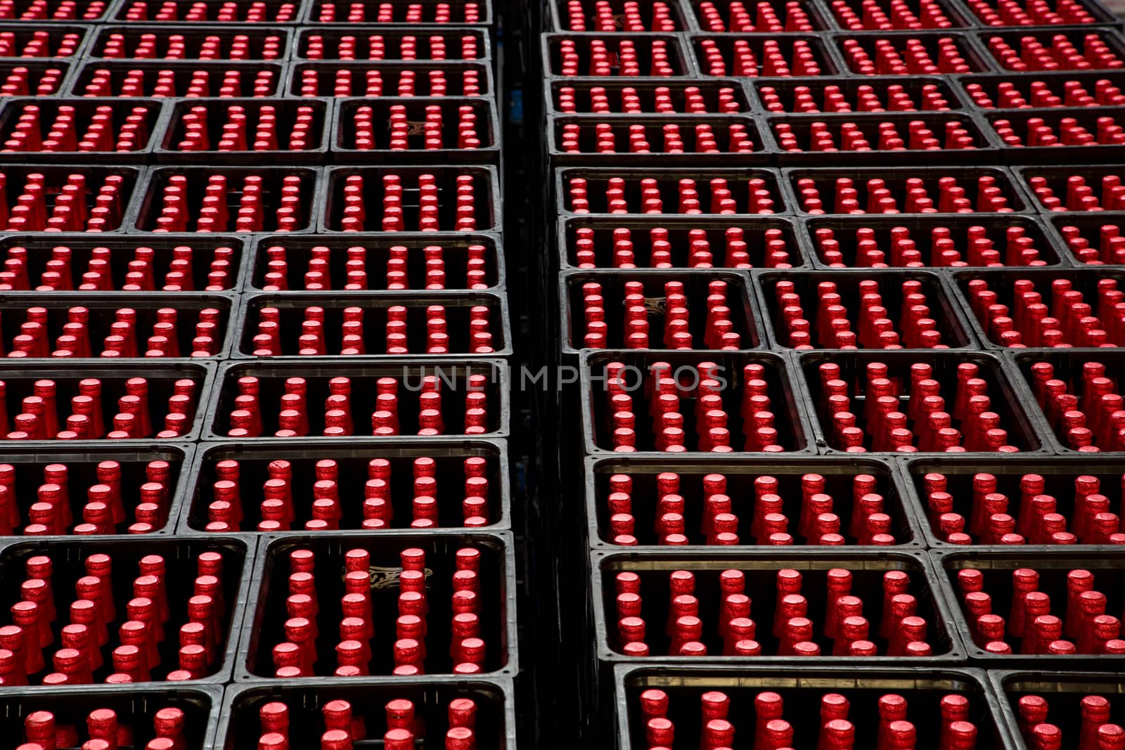 A group of red bottles in beer crates