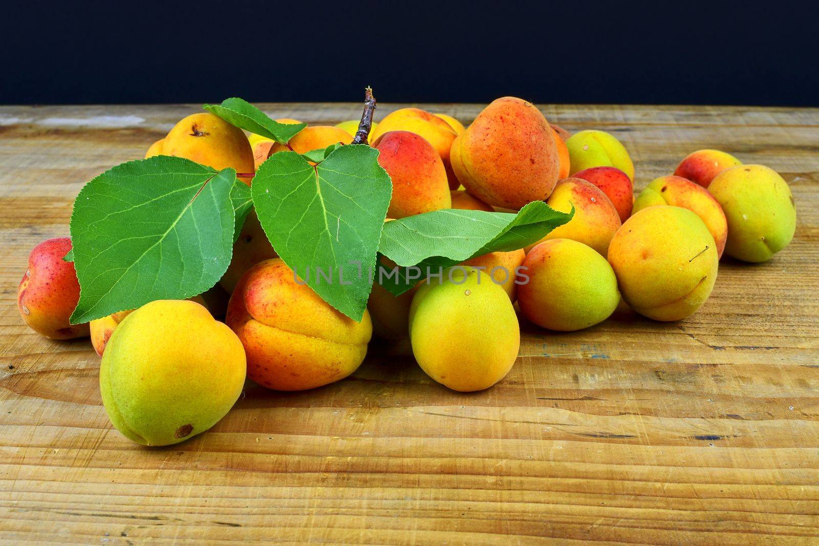 Apricots on wooden background. Apricots from rural garden. Close-up. by roman_nerud