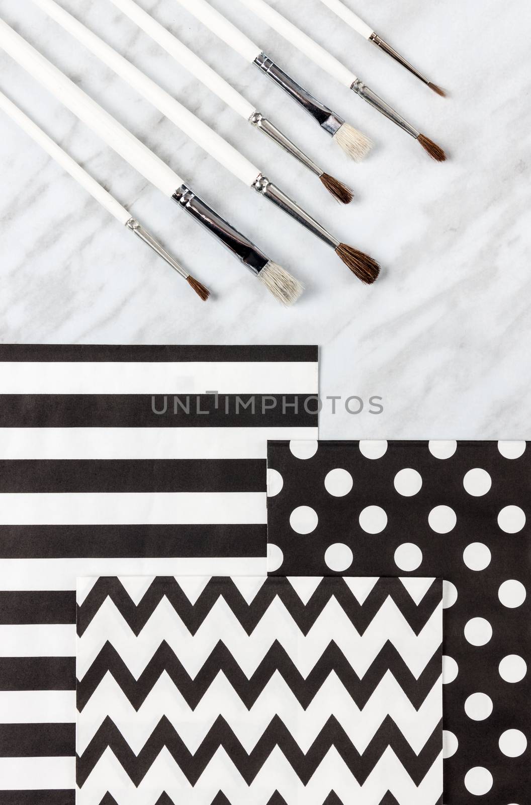 Paint brushes and decorative paper for arts and crafts by anikasalsera