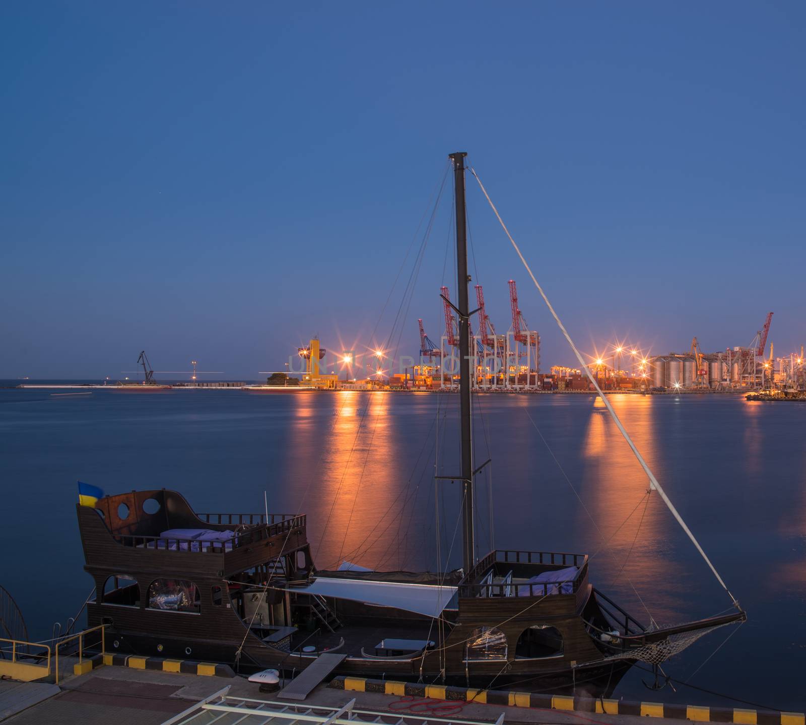 ODESSA, UKRAINE - 06.19.2018. Panoramic view of sea port and cargo terminal from the side of the sea terminal at summer sunset