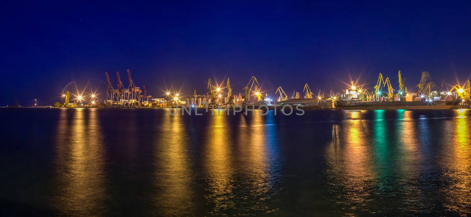 ODESSA, UKRAINE - 06.19.2018. Panoramic view of sea port and cargo terminal from the side of the sea terminal at summer sunset