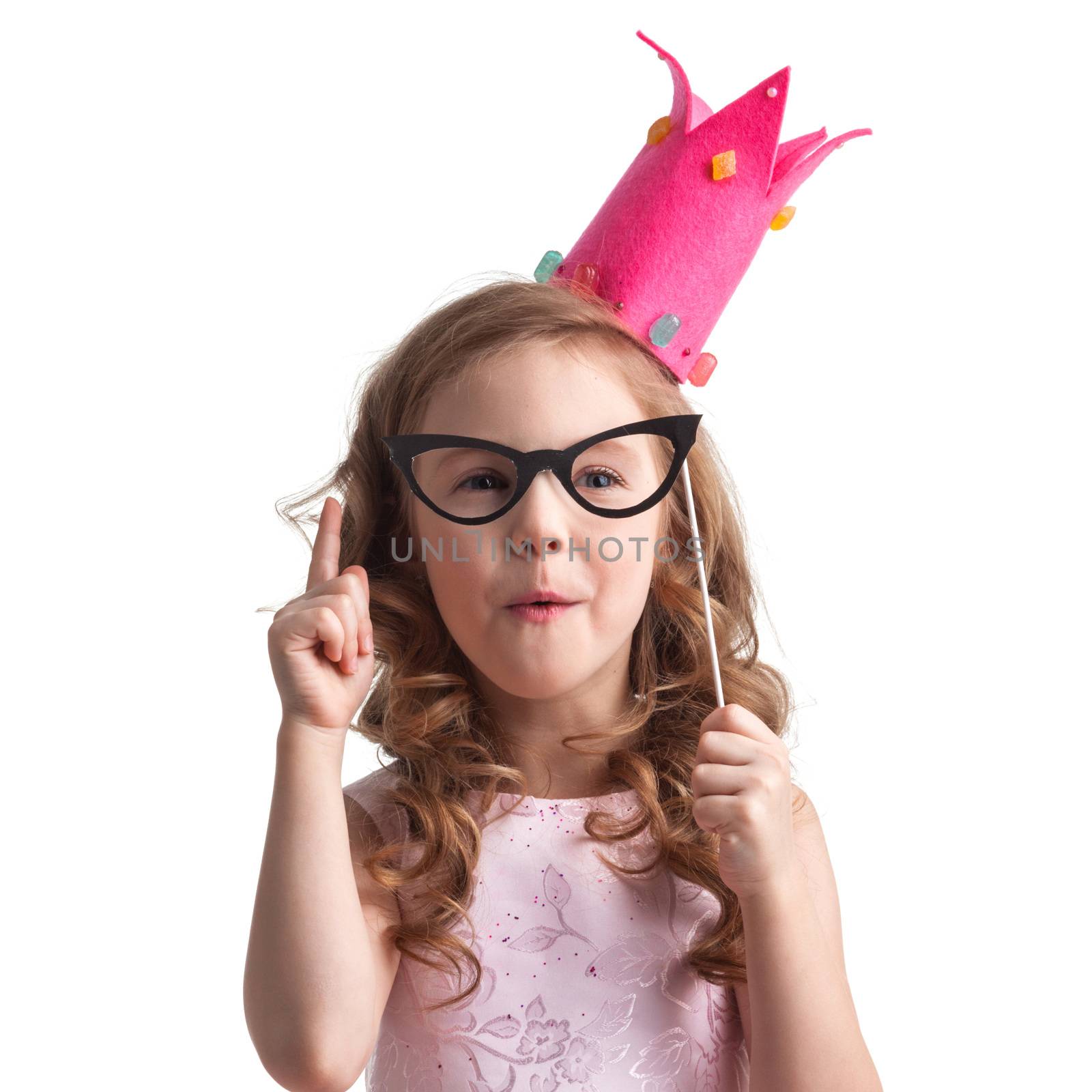 Funny princess girl in pink dress and crown holding party glasses on stick and saying something smart with finger up