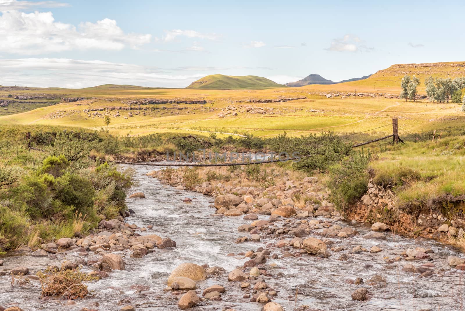 A pedestrian bridge over the Mlambonja River at the start of the three Pools hiking trail at Garden Castle in the Drakensberg