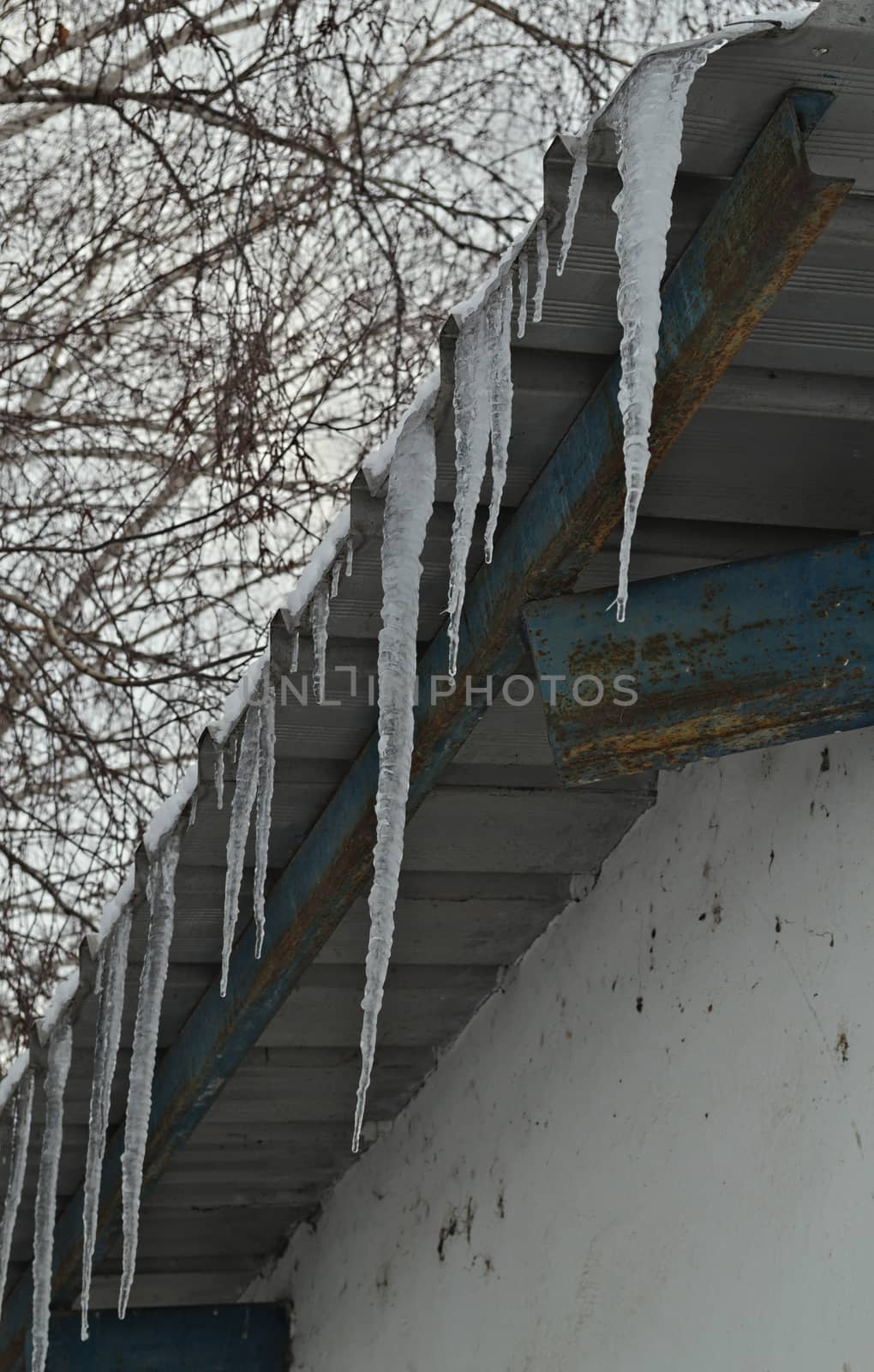 Frozen ice crystals hanging from roof top