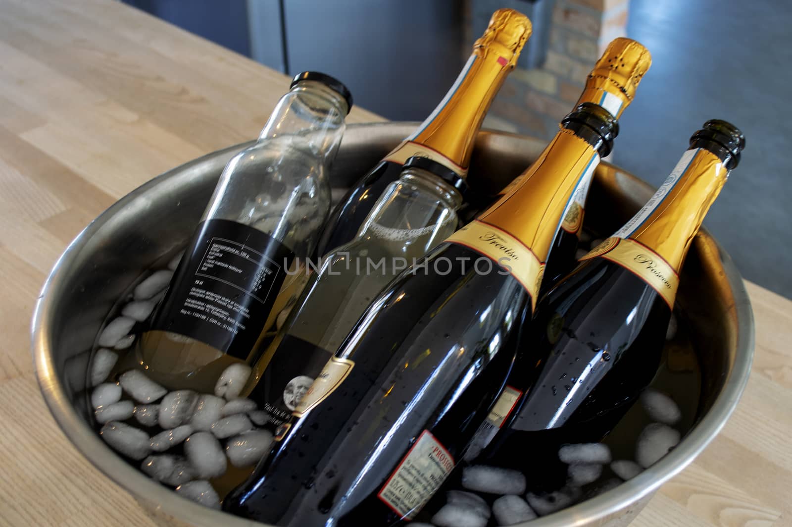 Wine and apple juice bottles in ice bucket by Mads_Hjorth_Jakobsen