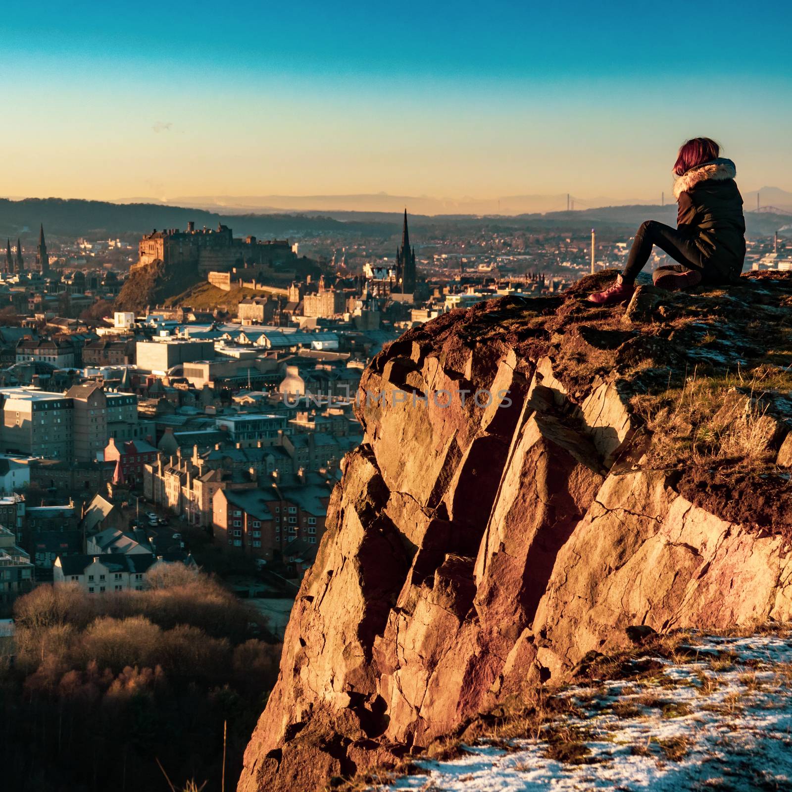 A Girl Overlooking The Beautiful Edinburgh Skyline And Castle During A Winter Sunset