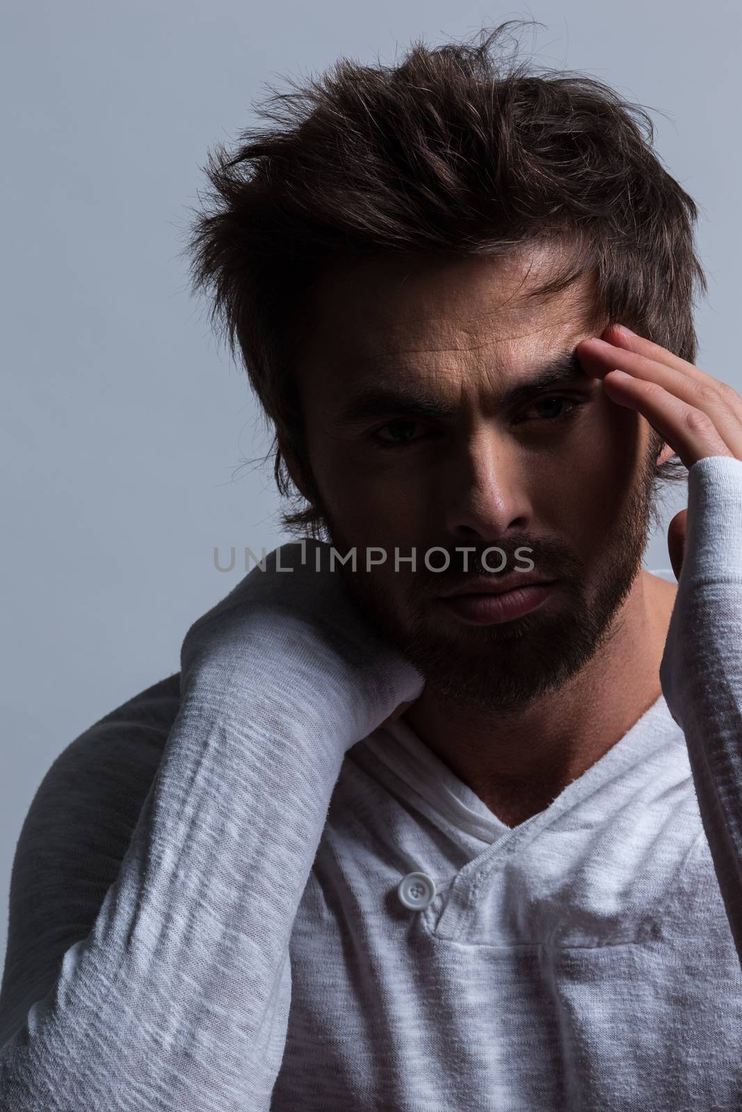 Close up portrait of Thoughtful, pensive and contemplating man thinking with shadow on face. Emotional and dramatic mood. Making hard decision. Despair, loneliness or insomnia concept.