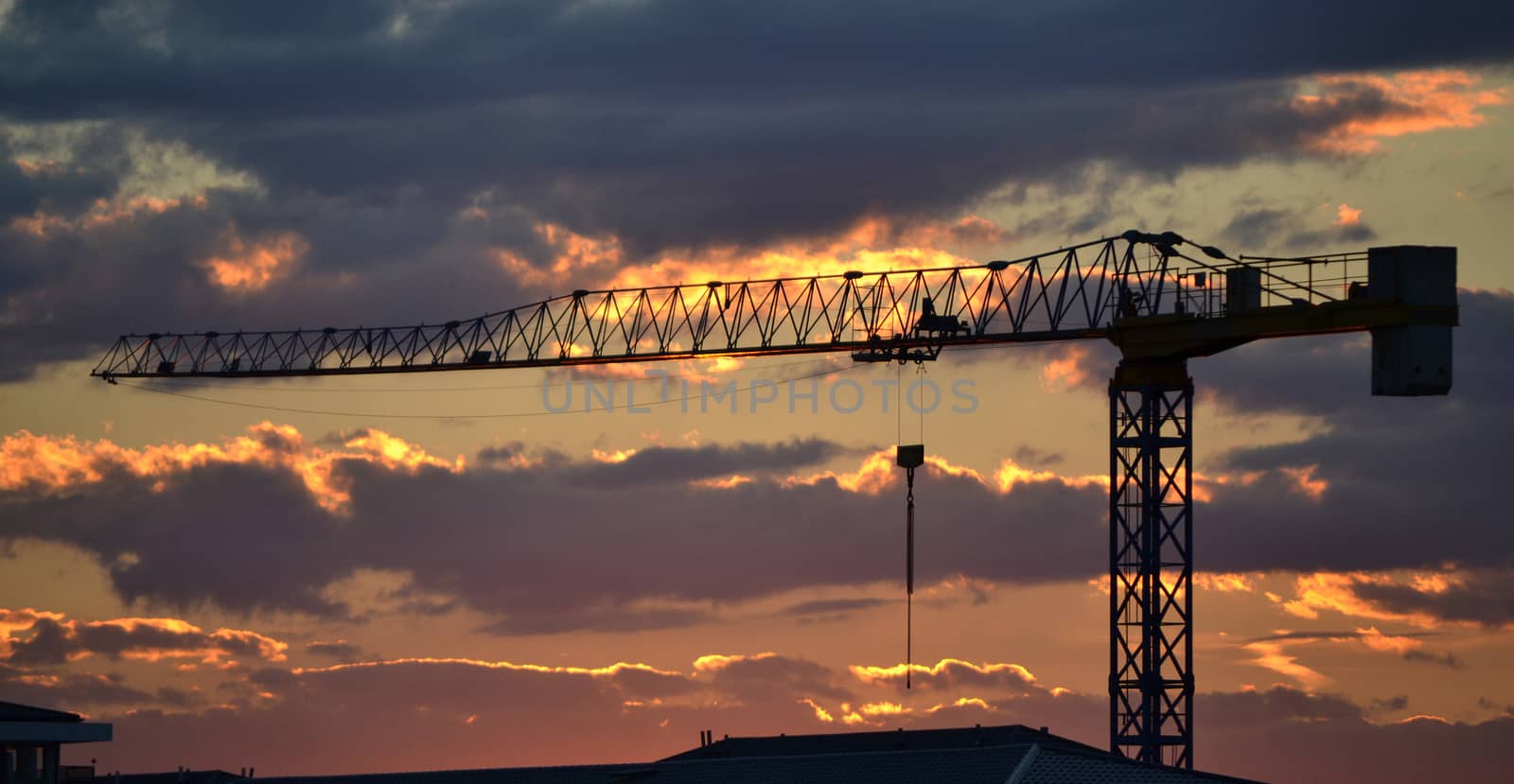 Construction crane at sunset