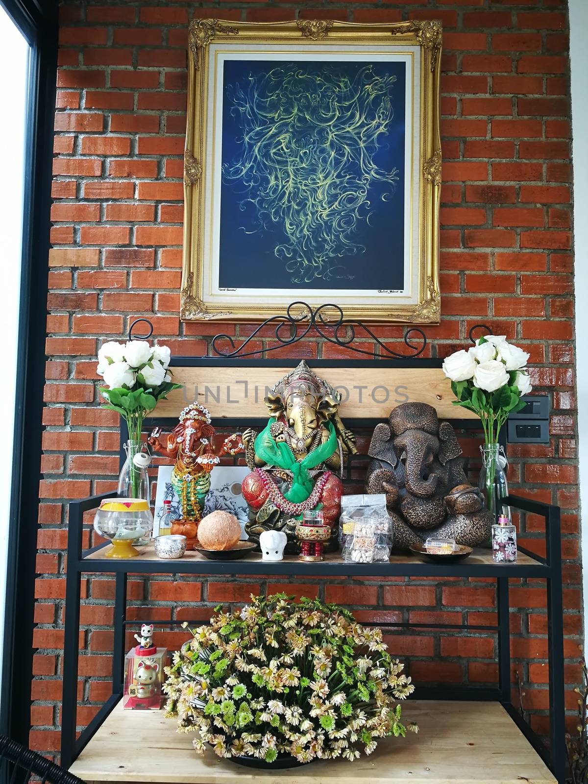 incense candles flowers cigarettes and  ceramic dolls  for Buddha statue and Thailand text were words to pray god