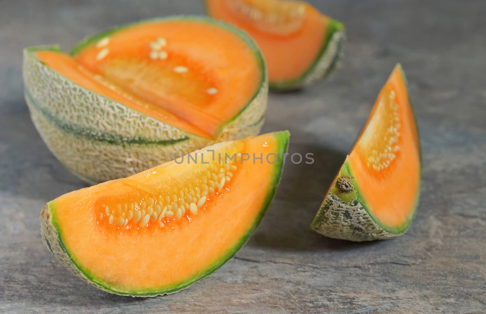 Fresh honeydew melon on stone table