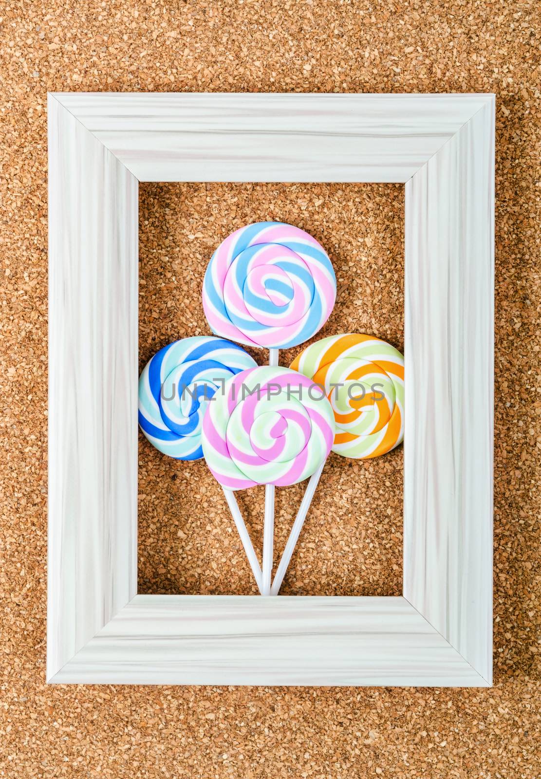 Colorful lollipop in vintage frame. by Gamjai