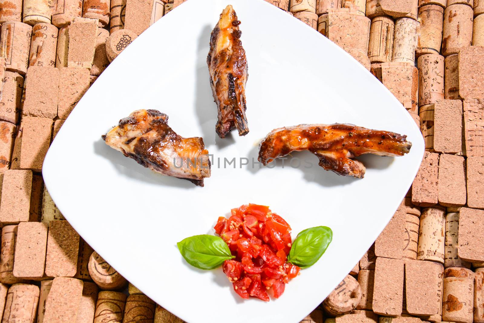 Italian ribs cooked on the grill and seasoned with cherry tomatoes