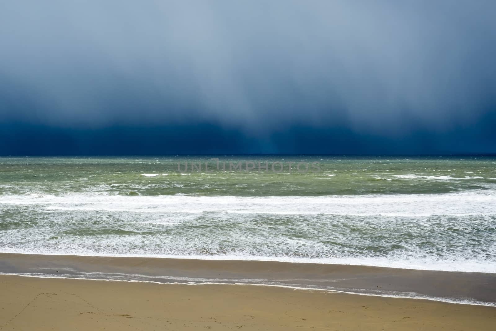 winter rain storm approaching beach by morrbyte
