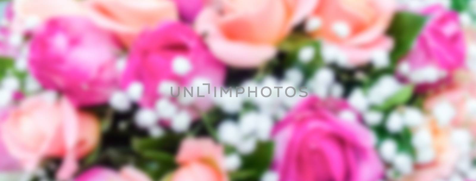 Defocused background with bouquet of roses. Intentionally blurred post production for bokeh effect