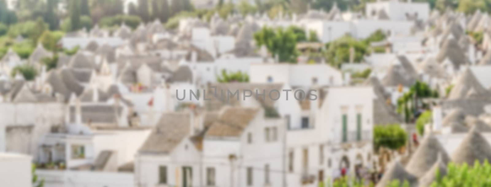Defocused background with typical trulli buildings in Alberobell by marcorubino