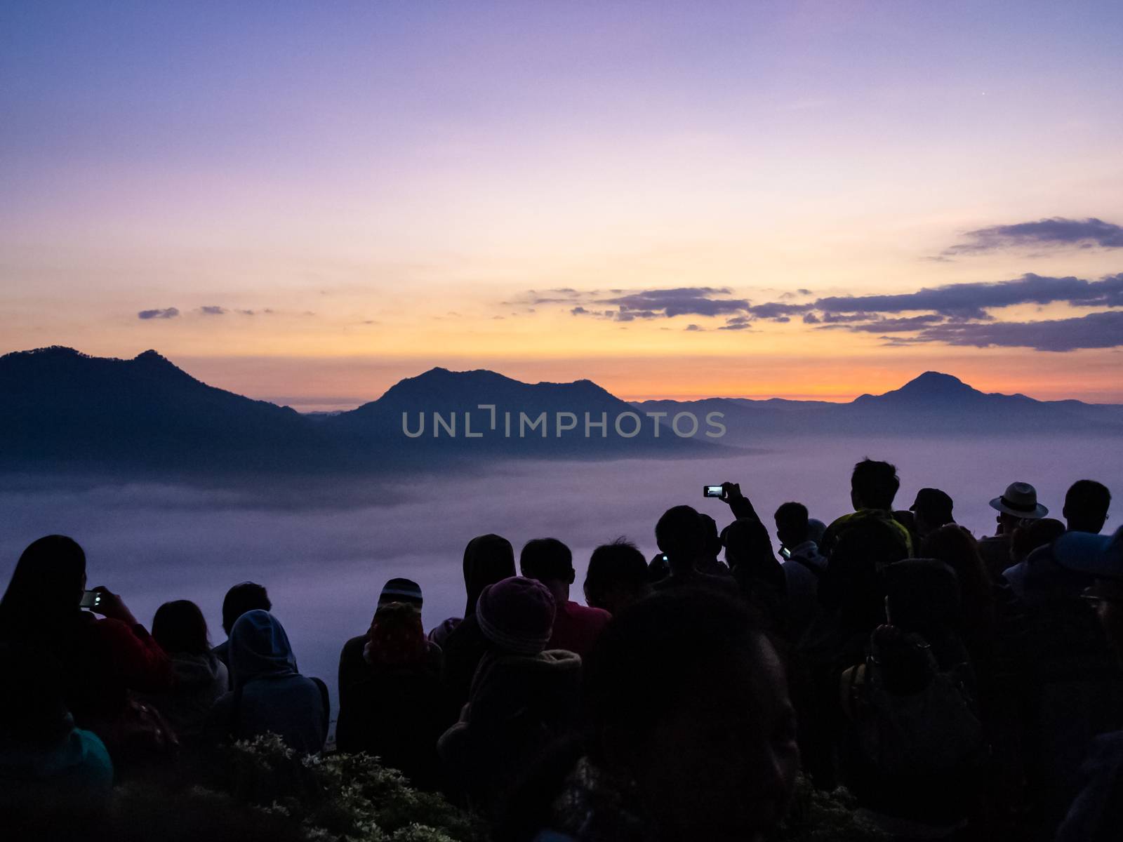 Many travellers looking at Sunrise and fog over Phu Thok Mountain at Chiang Khan ,Loei Province in Thailand.