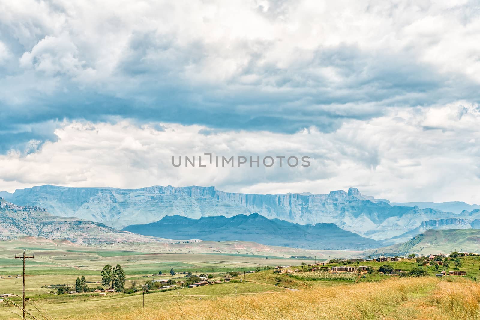 A township on the R74-road below the Oliviershoek Pass in Kwazulu-Natal. The Amphitheatre in the Drakensberg is visible in the back