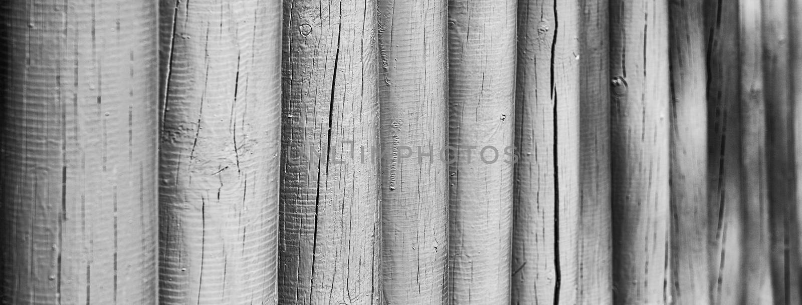 Closeup of a wooden fence, weathered and rough textured, suitable to be used as background. Selective focus