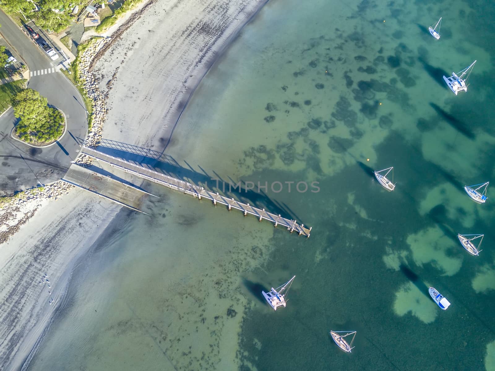 Early morning light down at the boat ramp and jetty.   The dark patches in the water is sea grass growing on the sand floor.