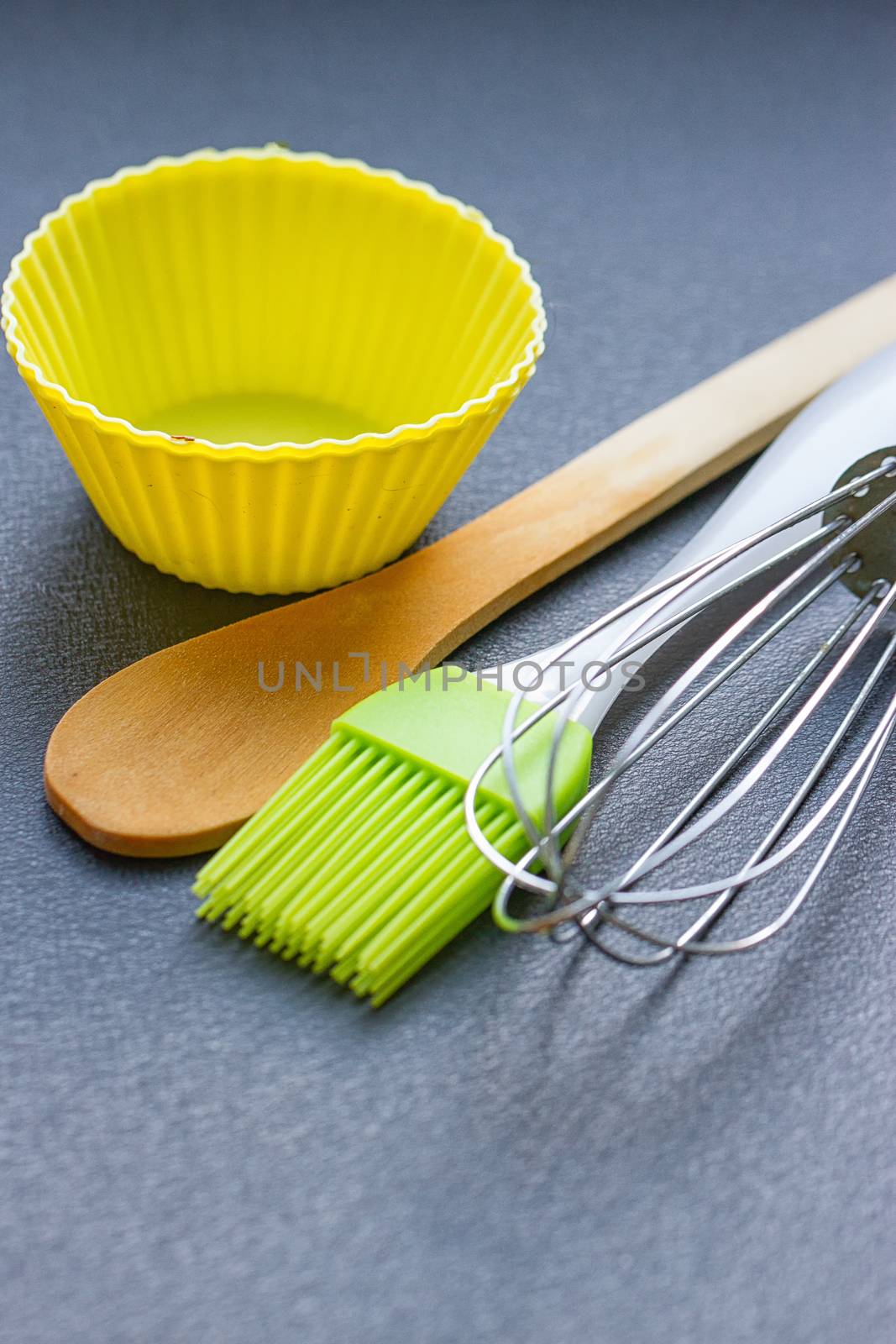 Rainbow silicone confectionery utensils on a blue background